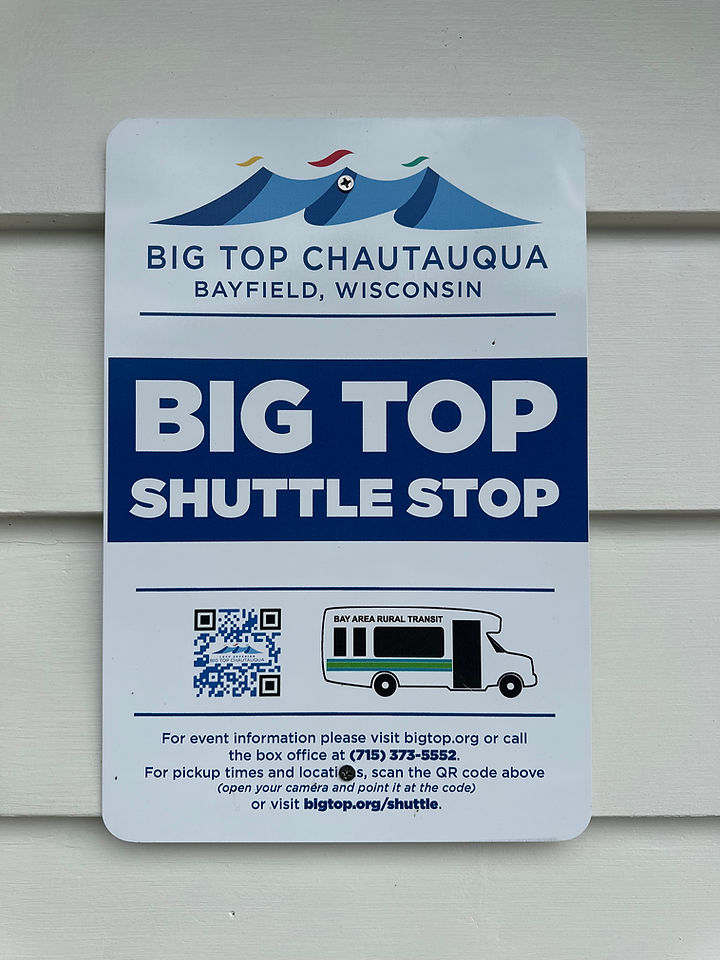 sign depicting teh blue big-top circus tent and Seagull Bay shuttle